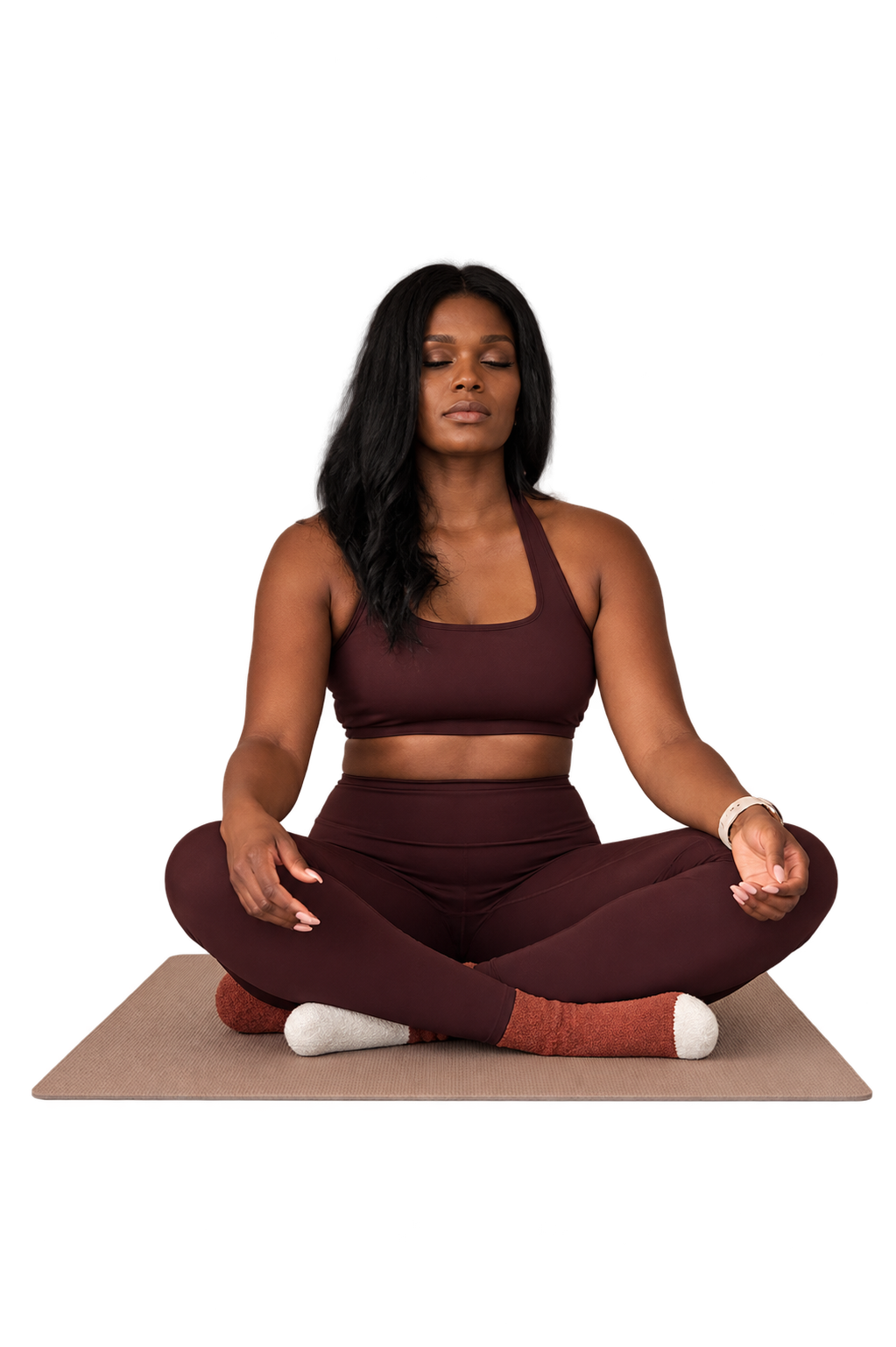 Elauq seated on a Pilates mat